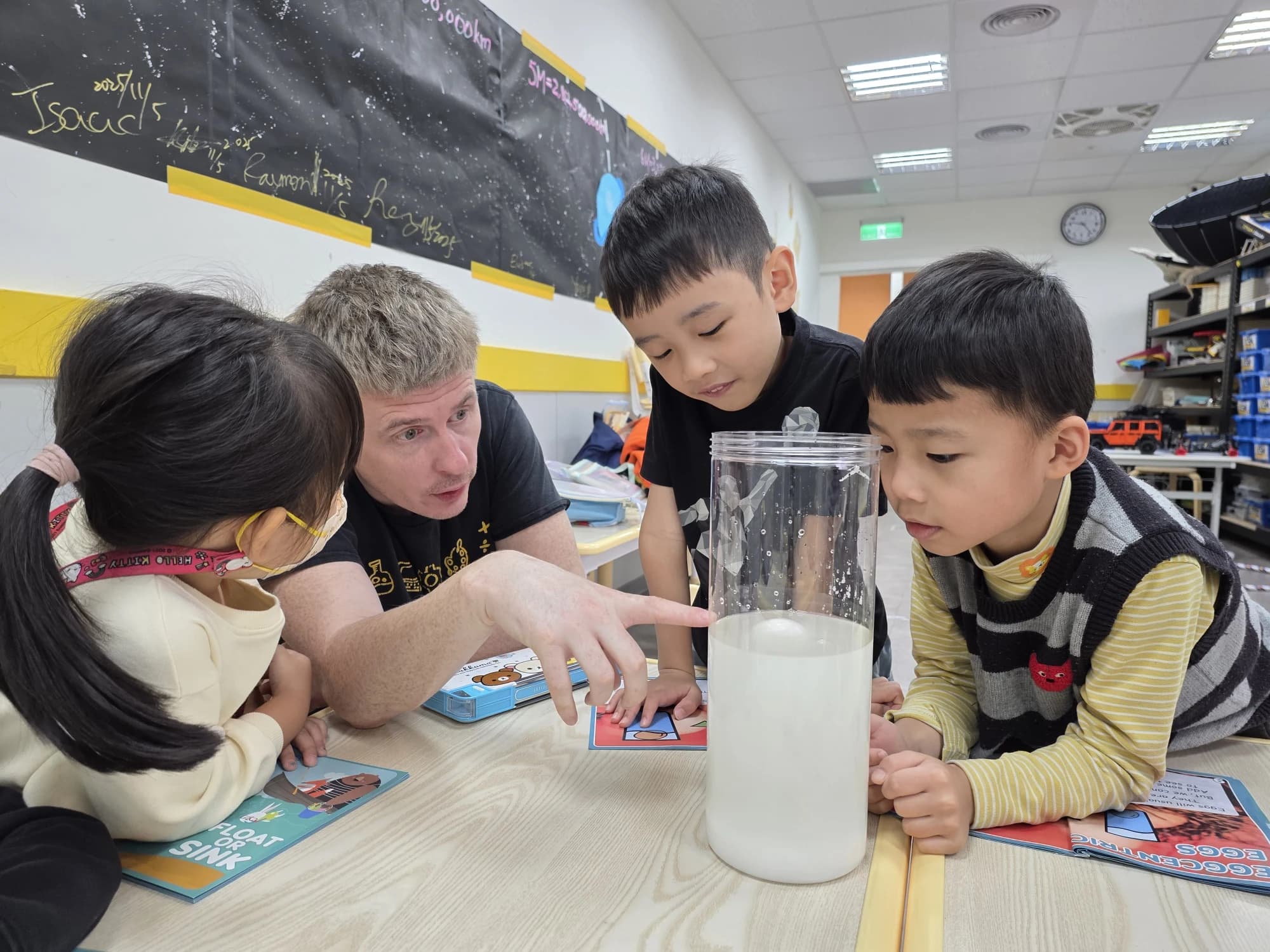 Tr. Paul guiding students through a hands-on science activity at STEAM SQUAD