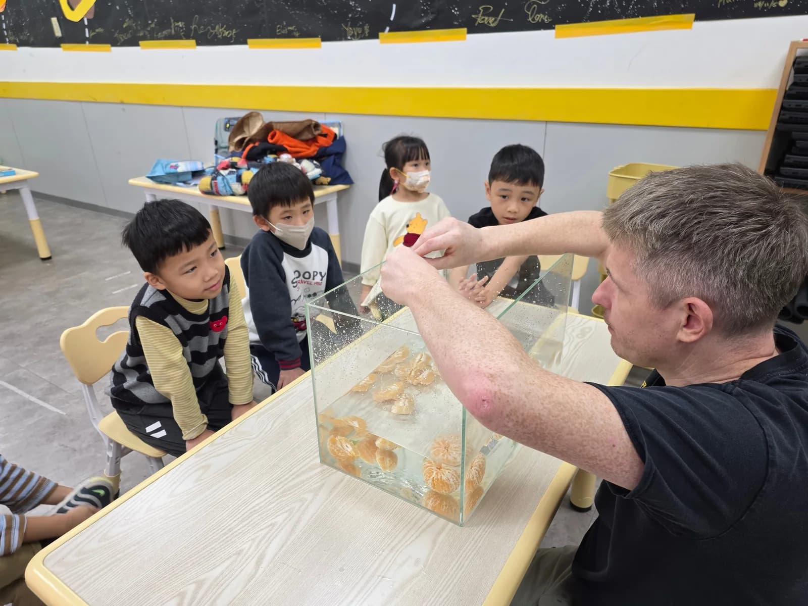 Children observing a live science demonstration at STEAM SQUAD