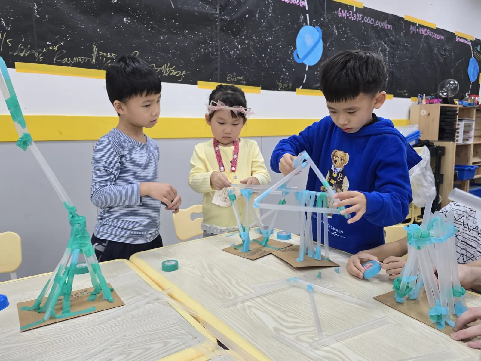 First Steps students engineering tall structures together