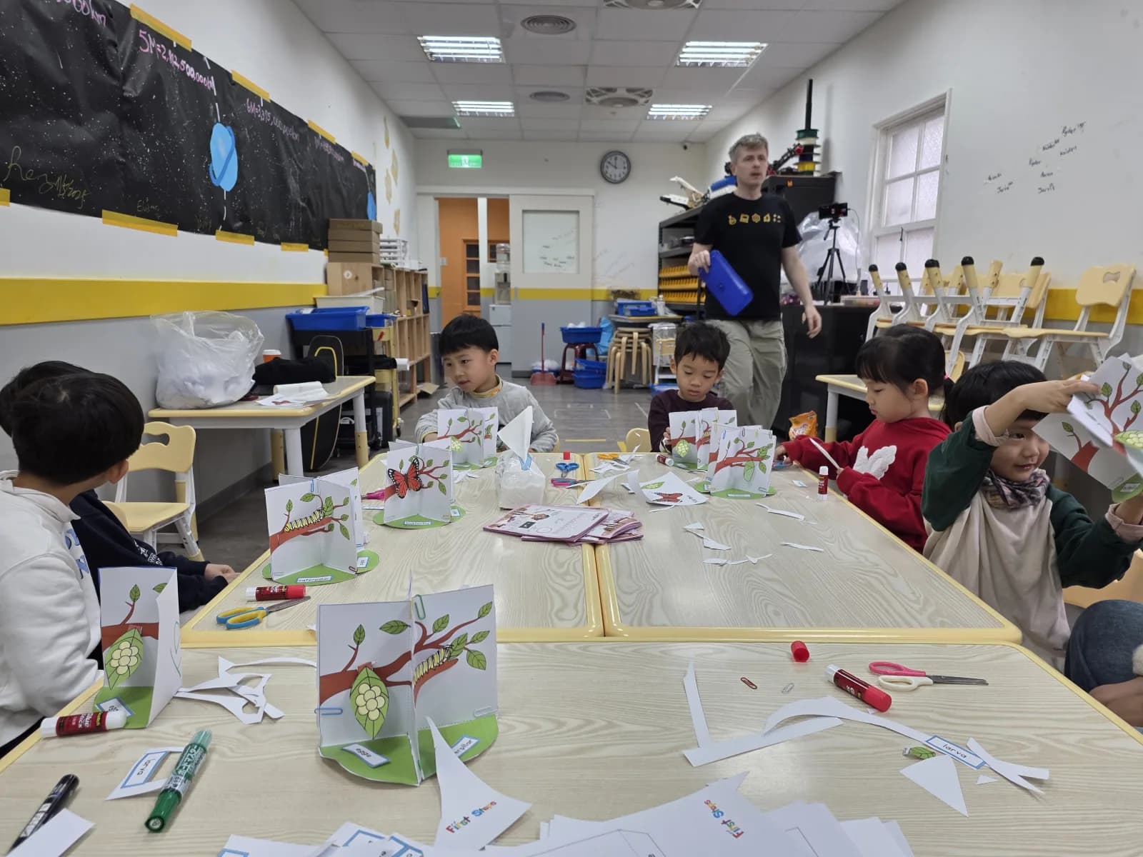 Children creating life-cycle pop-up models in a First Steps class