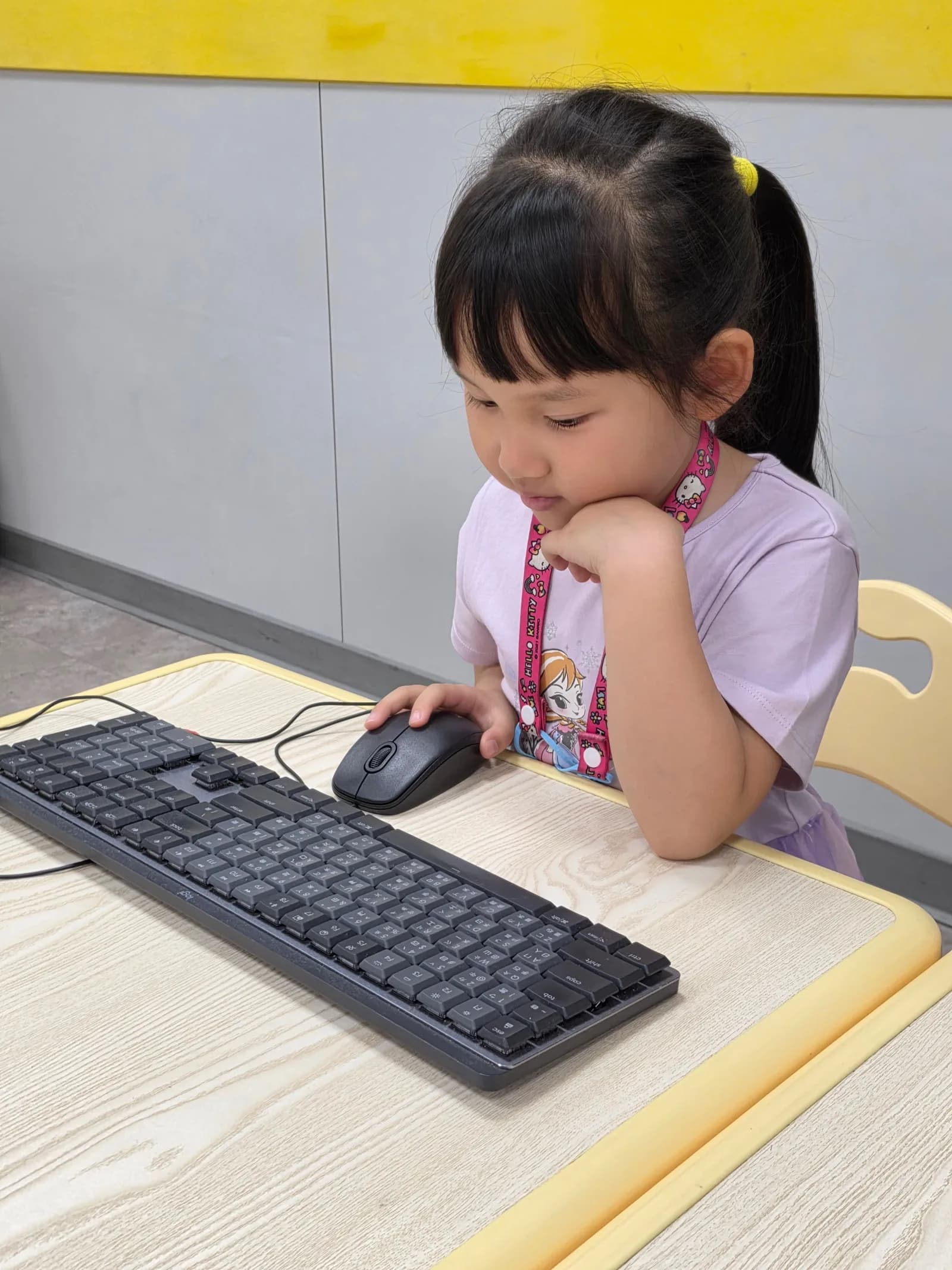 A student learning how a mouse and keyboard control a computer