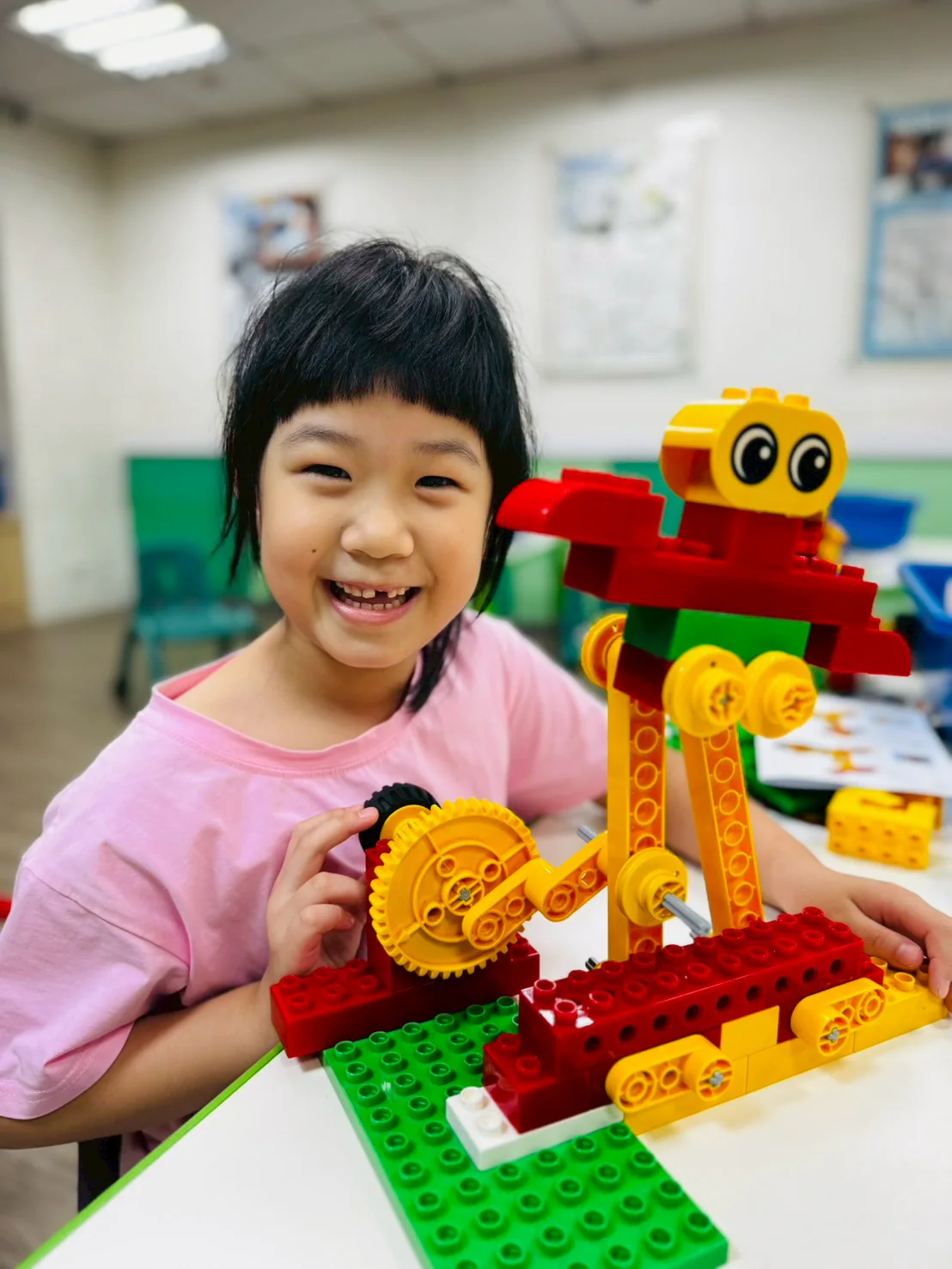 An ESM student pointing to the moving gears on a LEGO Dancer
