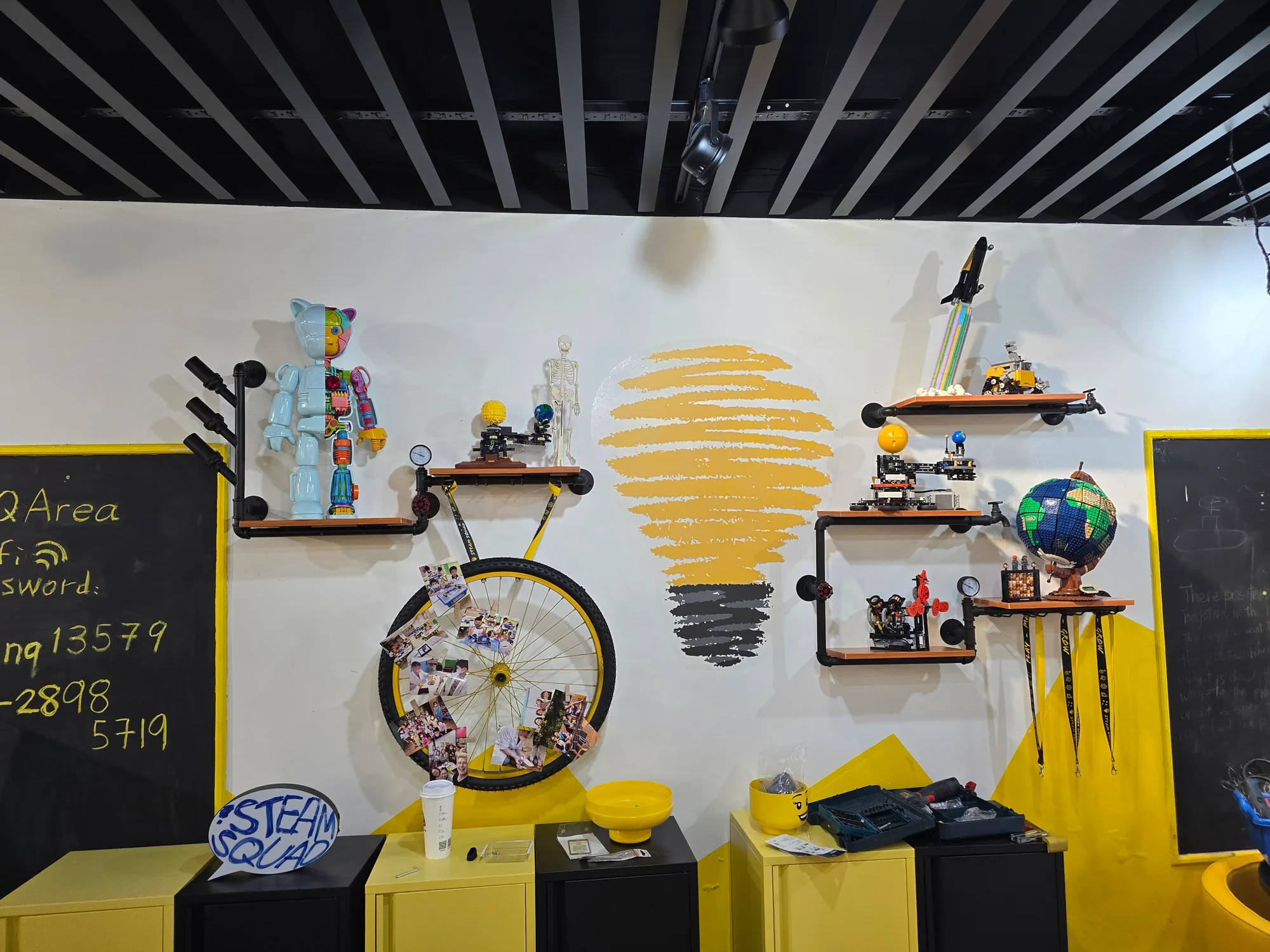 The STEAM SQUAD studio wall displaying engineering projects